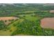 Aerial view of a property with a mix of woodland and farmland at 24686 Barbees Grove Rd, Oakboro, NC 28129