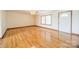 Hardwood floors, large windows, ceiling fan, and white walls at 24686 Barbees Grove Rd, Oakboro, NC 28129