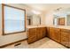 Double vanity bathroom with wood cabinets and tile flooring at 24686 Barbees Grove Rd, Oakboro, NC 28129