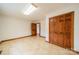 Bright bonus room featuring tile floors and built-in wooden closet at 24686 Barbees Grove Rd, Oakboro, NC 28129