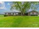 Brick ranch house, large yard, mature tree, front view at 24686 Barbees Grove Rd, Oakboro, NC 28129