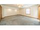Spacious bedroom with carpeted floor, ceiling fan, and window with blinds at 24686 Barbees Grove Rd, Oakboro, NC 28129