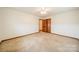 Well-lit bedroom with neutral carpeting and a ceiling fan at 24686 Barbees Grove Rd, Oakboro, NC 28129