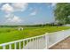 View of farm from deck, green fields, shed, and trees at 24686 Barbees Grove Rd, Oakboro, NC 28129