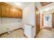 Convenient laundry room with built-in cabinets and tiled floor at 24686 Barbees Grove Rd, Oakboro, NC 28129