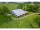 Aerial view of a barn with a metal roof and open sides at 24686 Barbees Grove Rd, Oakboro, NC 28129