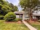 Brick townhouse with gray shutters and landscaped front yard at 10875 Holly Ridge Blvd, Charlotte, NC 28216