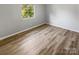 Empty bedroom showcasing light gray walls and wood-look floors at 3021 Heathstead Pl # D, Charlotte, NC 28210