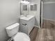 Modern bathroom with a white vanity and toilet at 3021 Heathstead Pl # D, Charlotte, NC 28210