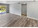 Spacious living room featuring wood-look floors and access to a balcony at 3021 Heathstead Pl # D, Charlotte, NC 28210