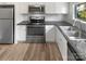 Modern kitchen with white cabinets and stainless steel appliances at 3021 Heathstead Pl # D, Charlotte, NC 28210