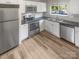 Modern kitchen with white cabinets, stainless steel appliances, and dark countertops at 3021 Heathstead Pl # D, Charlotte, NC 28210