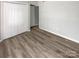 Well-lit bedroom featuring double door closet and wood-look floors at 3021 Heathstead Pl # D, Charlotte, NC 28210