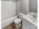 Clean bathroom with white tile, a bathtub, and a vanity with sink at 3021 Heathstead Pl # D, Charlotte, NC 28210