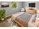 Bright bedroom with wood-look floors, featuring a comfortable bed and stylish furniture at 3021 Heathstead Pl # D, Charlotte, NC 28210