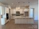 Bright kitchen featuring white cabinetry, quartz countertops, and an island at 5224 Glenwalk Dr # 0005, Charlotte, NC 28269