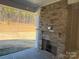 Stone fireplace on covered patio overlooking backyard at 5224 Glenwalk Dr # 0005, Charlotte, NC 28269