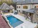 Luxury estate with expansive pool, patio, and outdoor kitchen at 9044 Island Point Rd, Charlotte, NC 28278