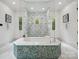 Spa-like bathroom with a walk-in shower and free-standing tub at 9044 Island Point Rd, Charlotte, NC 28278