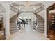 Grand foyer featuring a stunning double staircase, elegant chandelier, and piano at 9044 Island Point Rd, Charlotte, NC 28278