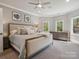 Spacious main bedroom with large bed, dresser and plenty of natural light at 9044 Island Point Rd, Charlotte, NC 28278