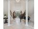 Elegant entryway with a grand staircase, high ceilings, and a view to the backyard at 9044 Island Point Rd, Charlotte, NC 28278