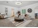 Spacious sitting area with comfortable seating and a large chandelier at 9044 Island Point Rd, Charlotte, NC 28278