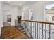 Bright upper hallway with hardwood floors and an arched doorway at 9044 Island Point Rd, Charlotte, NC 28278