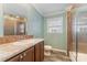 Clean bathroom with a shower/tub combo, wood-look floor, and neutral vanity at 159 Badin Lake Cir, New London, NC 28127