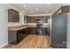 Modern kitchen with dark wood cabinets and stainless steel appliances at 159 Badin Lake Cir, New London, NC 28127