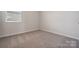 Simple bedroom with carpet, window, and neutral walls at 609 Cashion Rd, York, SC 29745