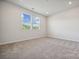 Spacious bedroom with neutral carpeting and two windows at 609 Cashion Rd, York, SC 29745