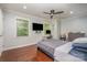 Spacious bedroom with hardwood floors, ceiling fan, and large windows at 6200 Old Providence Rd, Charlotte, NC 28226