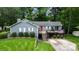 Gray house with red door, deck, and American flag, on a grassy lot at 6200 Old Providence Rd, Charlotte, NC 28226