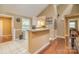Kitchen with breakfast bar, white cabinets and wood-look floors at 6200 Old Providence Rd, Charlotte, NC 28226
