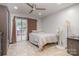 Bedroom with tile floor, sliding glass door to deck, and ceiling fan at 6200 Old Providence Rd, Charlotte, NC 28226
