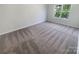 Bright bedroom with neutral carpeting and a large window at 7925 Donet Terrace Dr, Charlotte, NC 28215