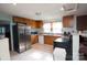 Kitchen with wood cabinets, stainless steel appliances, and tile floor at 301 W Washington Ave, Bessemer City, NC 28016