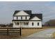 Two-story white farmhouse with black accents and a front porch at 1145 Philbeck Rd # 11, York, SC 29745