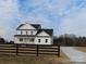 White two-story farmhouse with a black roof and a long driveway at 1187 Philbeck Rd # 13, York, SC 29745