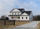 Two-story white farmhouse with black roof and a long driveway at 1187 Philbeck Rd # 13, York, SC 29745