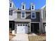 Gray two-story townhome with white garage door and landscaping at 5033 Falstone Dr, Charlotte, NC 28269