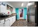 Kitchen with white cabinets, teal walls, and stainless steel appliances at 119 E May St, New London, NC 28127