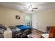 Bedroom with hardwood floors, bed, and pet crate at 15016 Rocky River Rd, Davidson, NC 28036