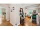Bright hallway with hardwood floors offering views into living room and kitchen at 15016 Rocky River Rd, Davidson, NC 28036