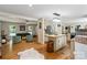 Open concept kitchen with island and view into living room at 15016 Rocky River Rd, Davidson, NC 28036