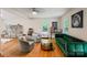 Spacious living room with hardwood floors, comfy seating and large artwork at 15016 Rocky River Rd, Davidson, NC 28036