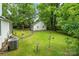 Landscaped backyard with detached workshop and lush greenery at 15016 Rocky River Rd, Davidson, NC 28036