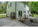 Spacious deck with seating area, fire pit, and birdcage overlooking backyard at 15016 Rocky River Rd, Davidson, NC 28036