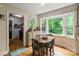 Kitchen dining area with wood table and view to backyard at 15016 Rocky River Rd, Davidson, NC 28036